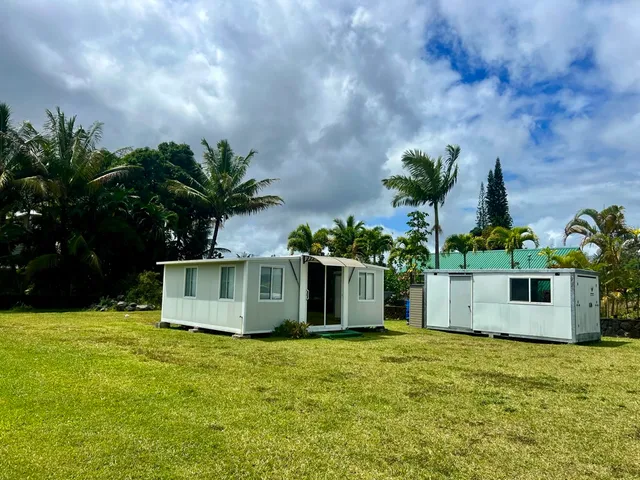 a view of a house with a garden and yard