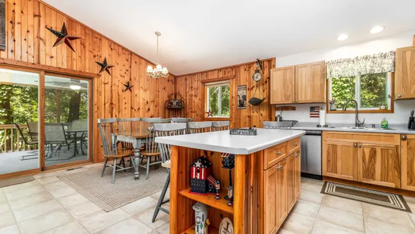 a kitchen with a sink stove and chairs
