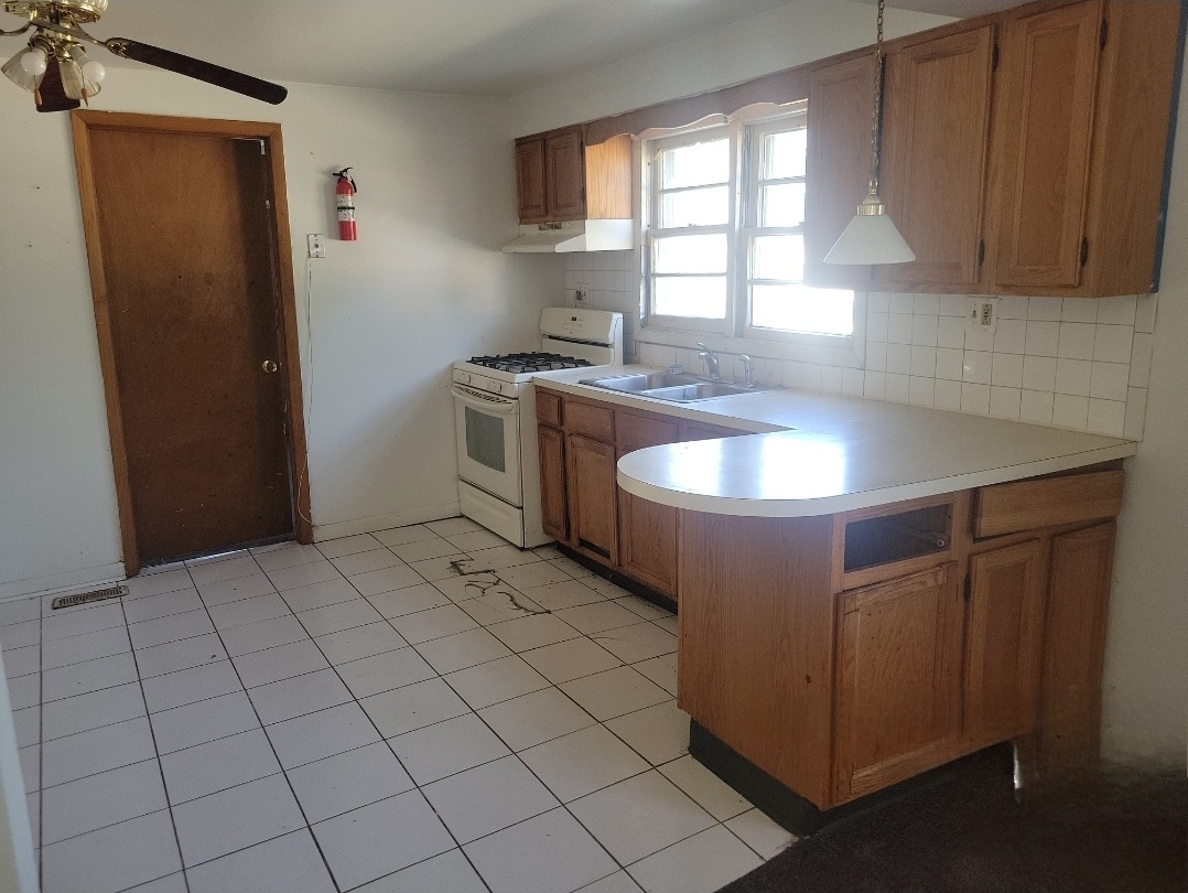 2100 14th Avenue Broadview, IL 60155 - Photo 4 of 14 a kitchen with a sink cabinets and window