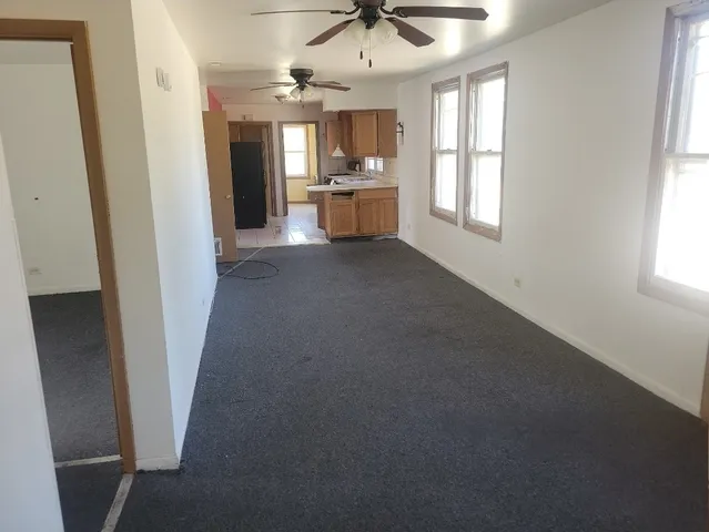 an empty room with a fireplace and windows