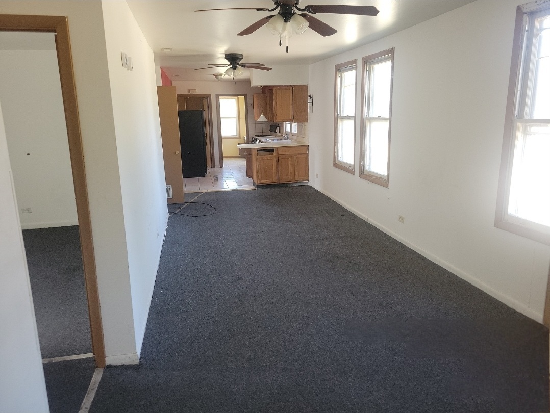 2100 14th Avenue Broadview, IL 60155 - Photo 8 of 14 an empty room with a fireplace and windows