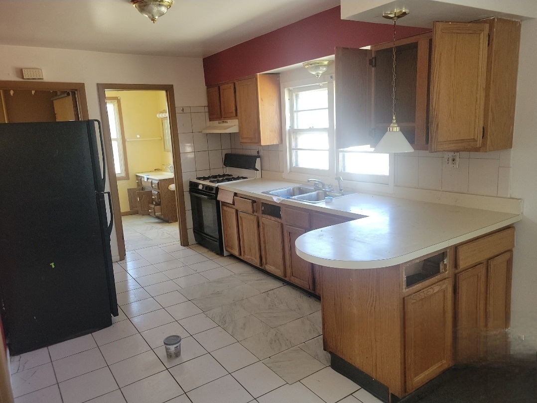 2100 14th Avenue Broadview, IL 60155 - Photo 9 of 14 a kitchen with stainless steel appliances granite countertop a sink stove and refrigerator