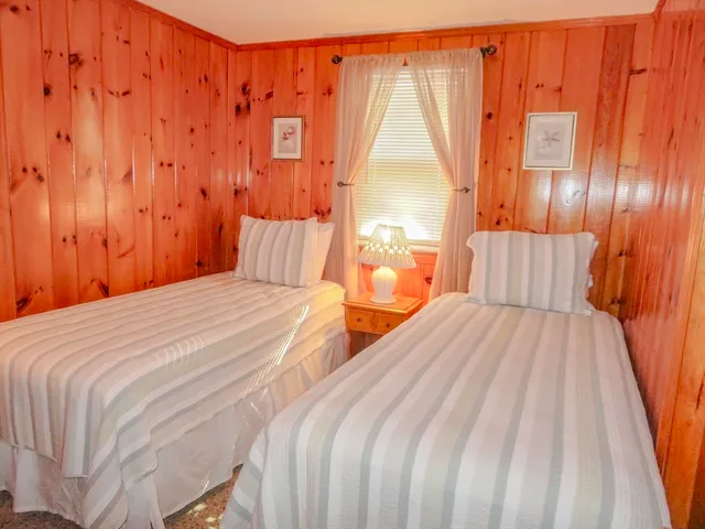 a bedroom with a bed and a curtain