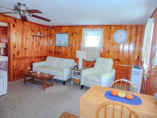a living room with furniture a rug and a chandelier