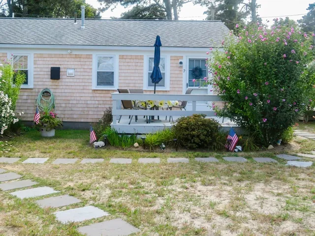 a view of a house with a yard and plants