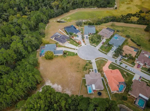 an aerial view of residential house with outdoor space and swimming pool