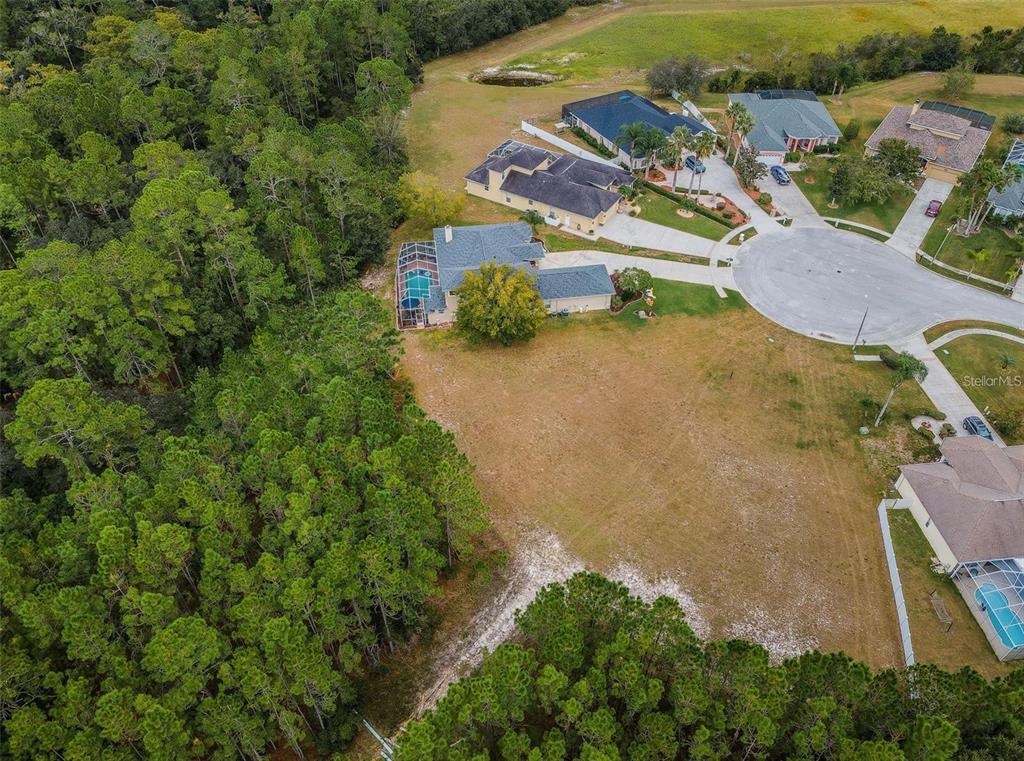 0 Shooting Star Court New Port Richey, FL 34655 - Photo 14 of 23 an aerial view of a house with a yard and lake view