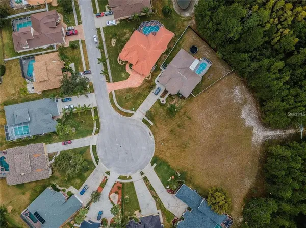 an aerial view of residential house with outdoor space and parking