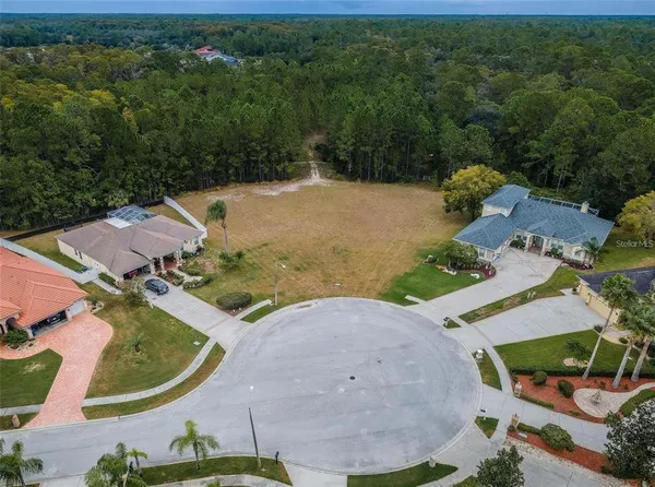 an aerial view of a house with yard swimming pool and outdoor seating