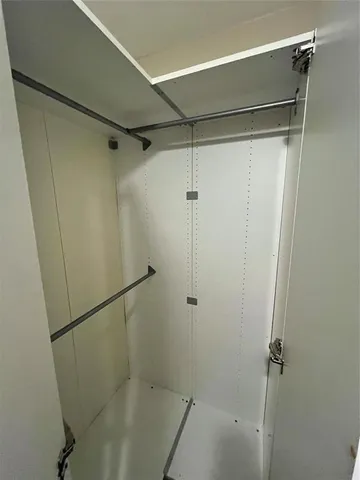 a view of closet with wooden floor