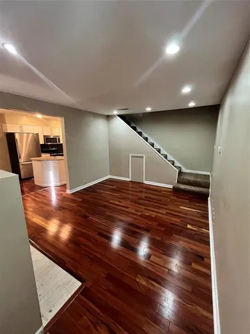a view of an empty room with wooden floor