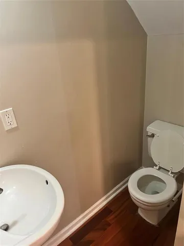 a white toilet sitting next to a white sink
