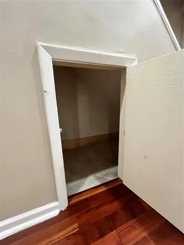 a spacious bathroom with a granite countertop sink a mirror and a toilet