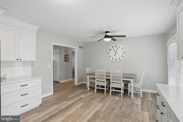 a dining room with a wooden table and chairs