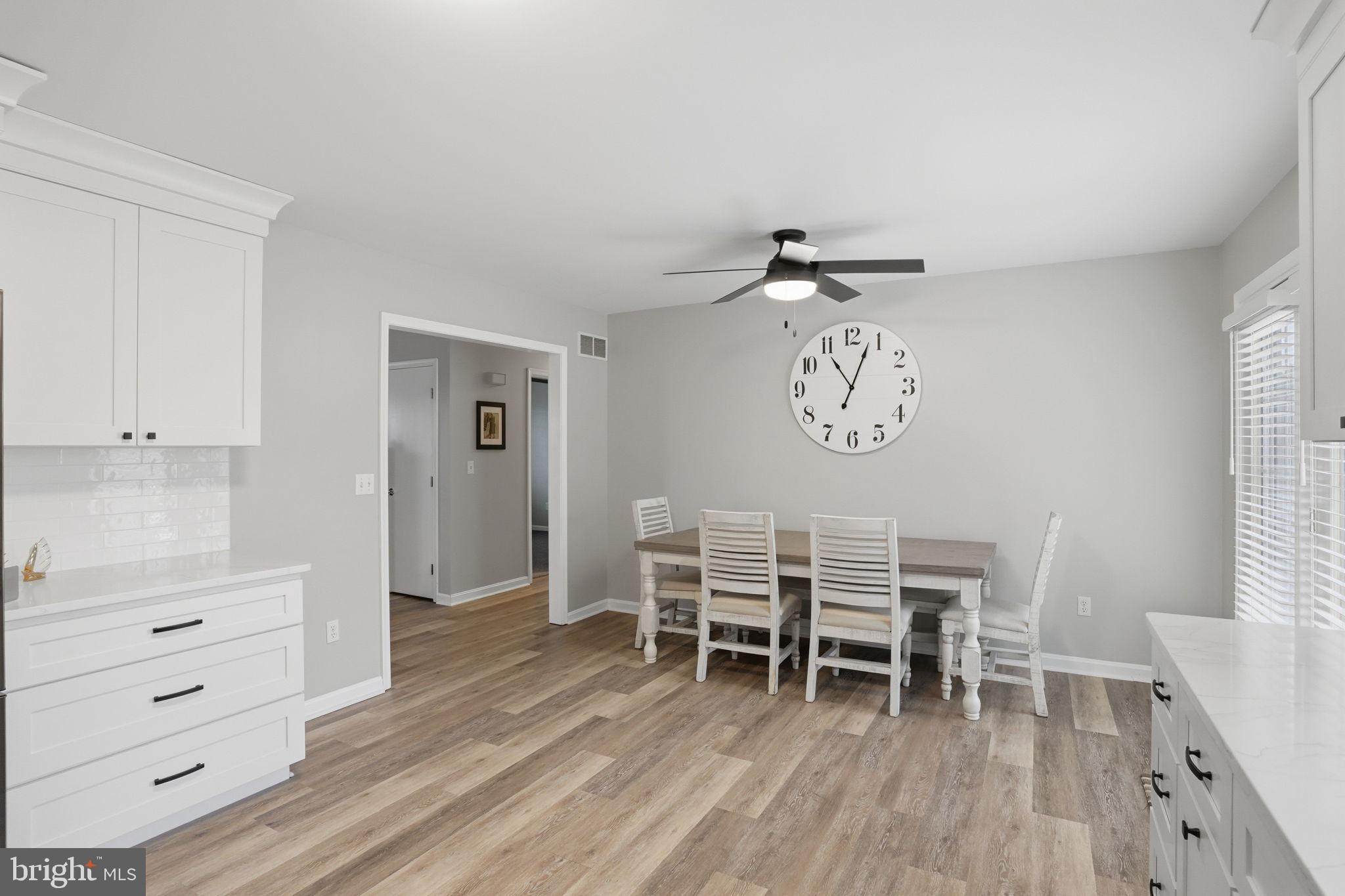 251 Misty Ridge Drive Magnolia, DE 19962 - Photo 11 of 33 a dining room with a wooden table and chairs