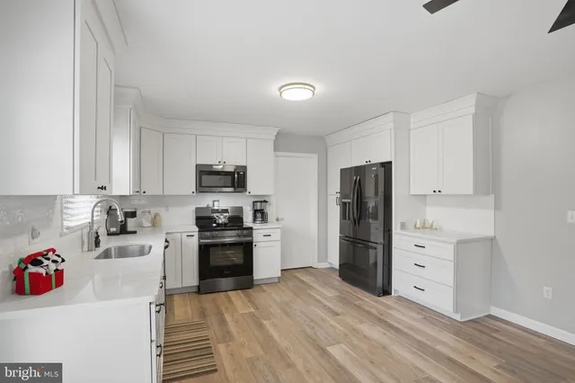 a kitchen with a refrigerator stove and wooden cabinets