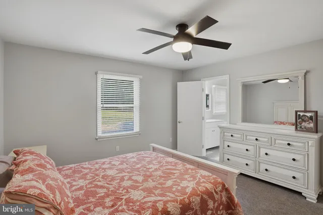 a bedroom with a baby bed and a window
