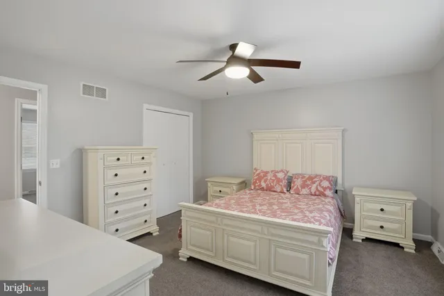 a bedroom with a bed and a tv