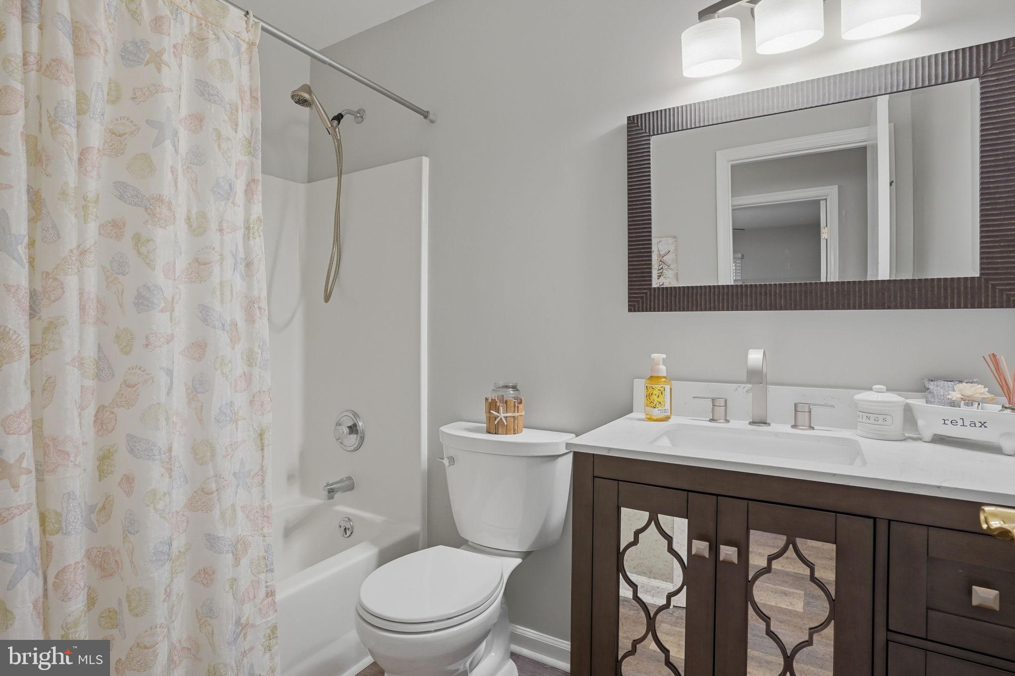 251 Misty Ridge Drive Magnolia, DE 19962 - Photo 20 of 33 a bathroom with a sink vanity mirror and toilet