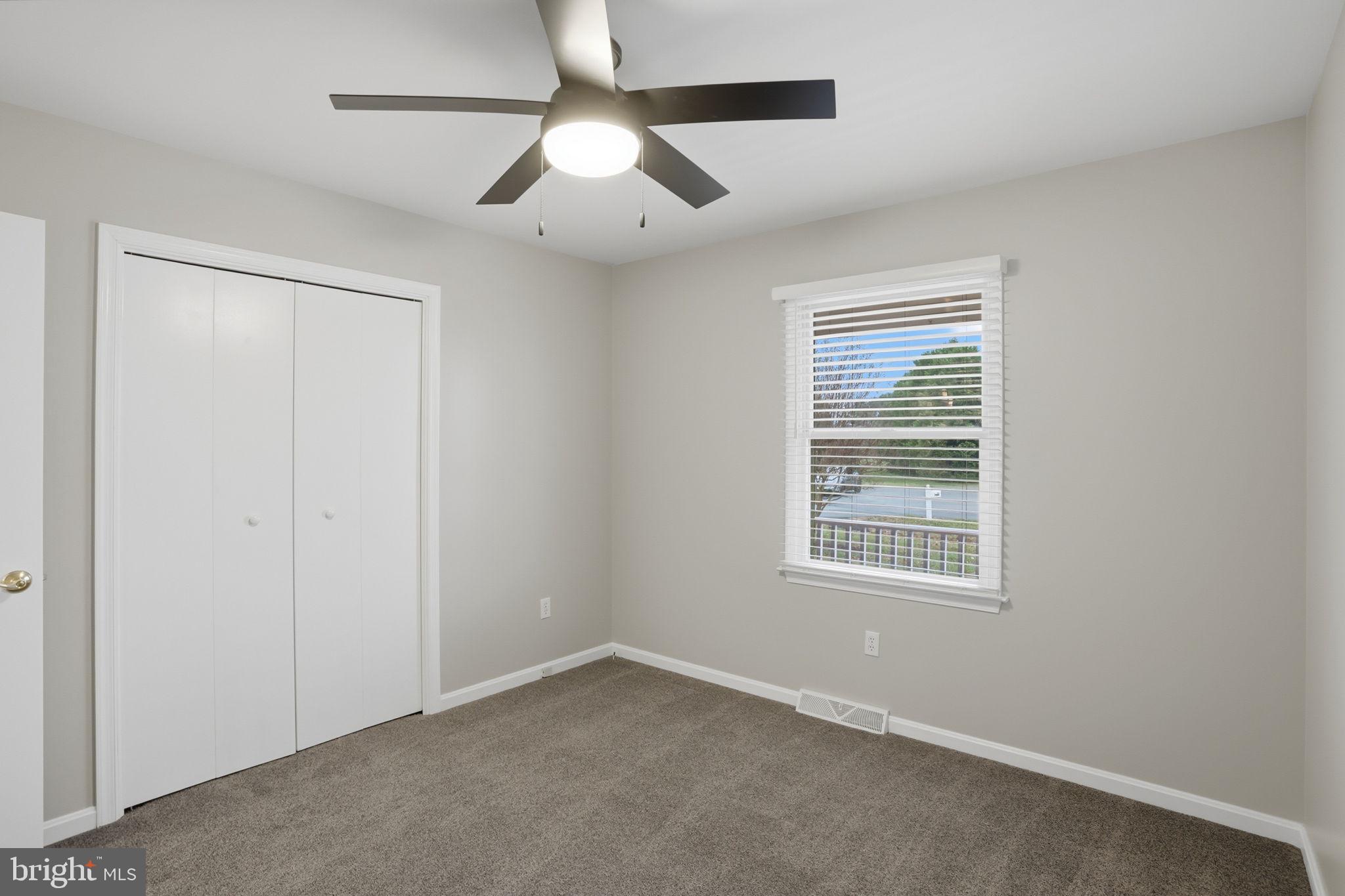 251 Misty Ridge Drive Magnolia, DE 19962 - Photo 22 of 33 an empty room with a window and a ceiling fan