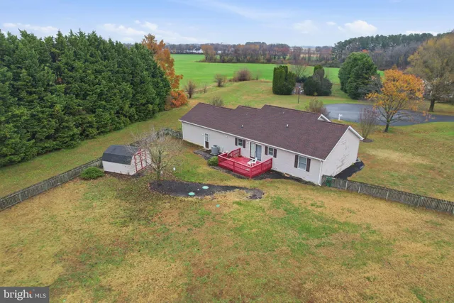 an aerial view of a house with a yard basket ball court and outdoor seating