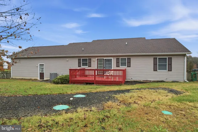 a front view of a house with a garden and yard
