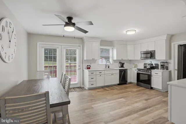 a kitchen with a refrigerator cabinets and wooden floor