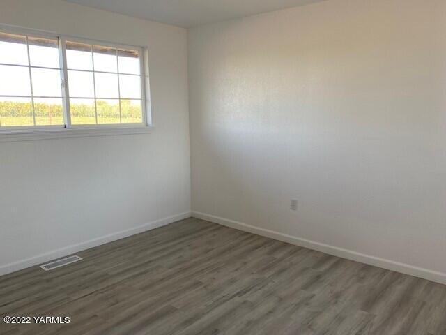 2807 Nelson Road Yakima, WA 98903 - Photo 4 of 11 an empty room with wooden floor and windows