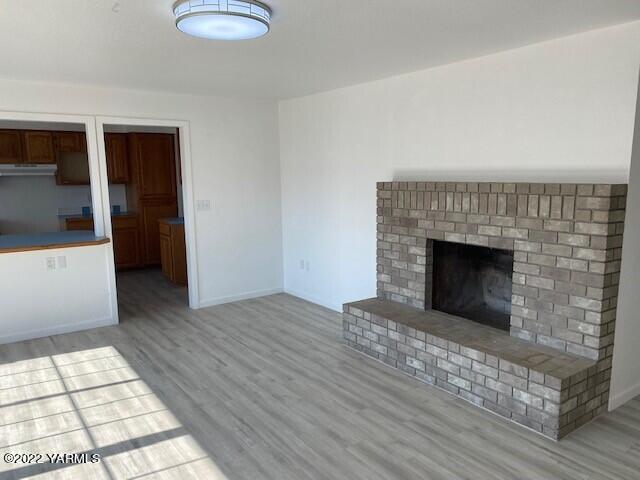 2807 Nelson Road Yakima, WA 98903 - Photo 10 of 11 a view of empty room with wooden floor and fireplace