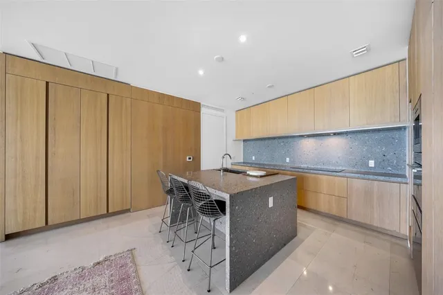 a view of a kitchen with dining area a sink and a refrigerator