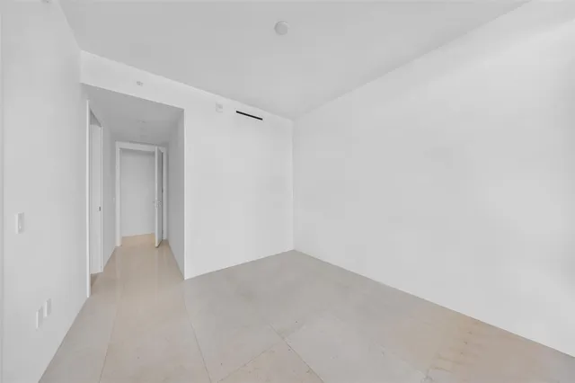 a bathroom with a sink a mirror and wooden floor