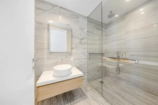 a living room with furniture and floor to ceiling windows