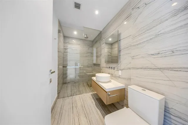 a living room with furniture potted plant and a large window