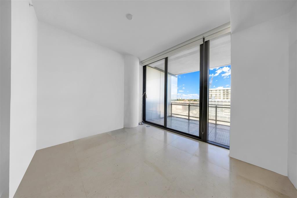 8701 Collins Avenue, Unit 701 Surfside, FL 33154 - Photo 33 of 91 an empty room with windows and entrance