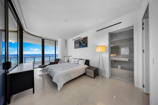 a bedroom with a large bed and a large window