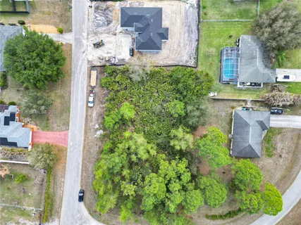 aerial view of a house with a yard and garden