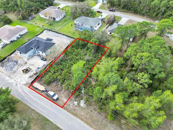 an aerial view of a residential houses with outdoor space
