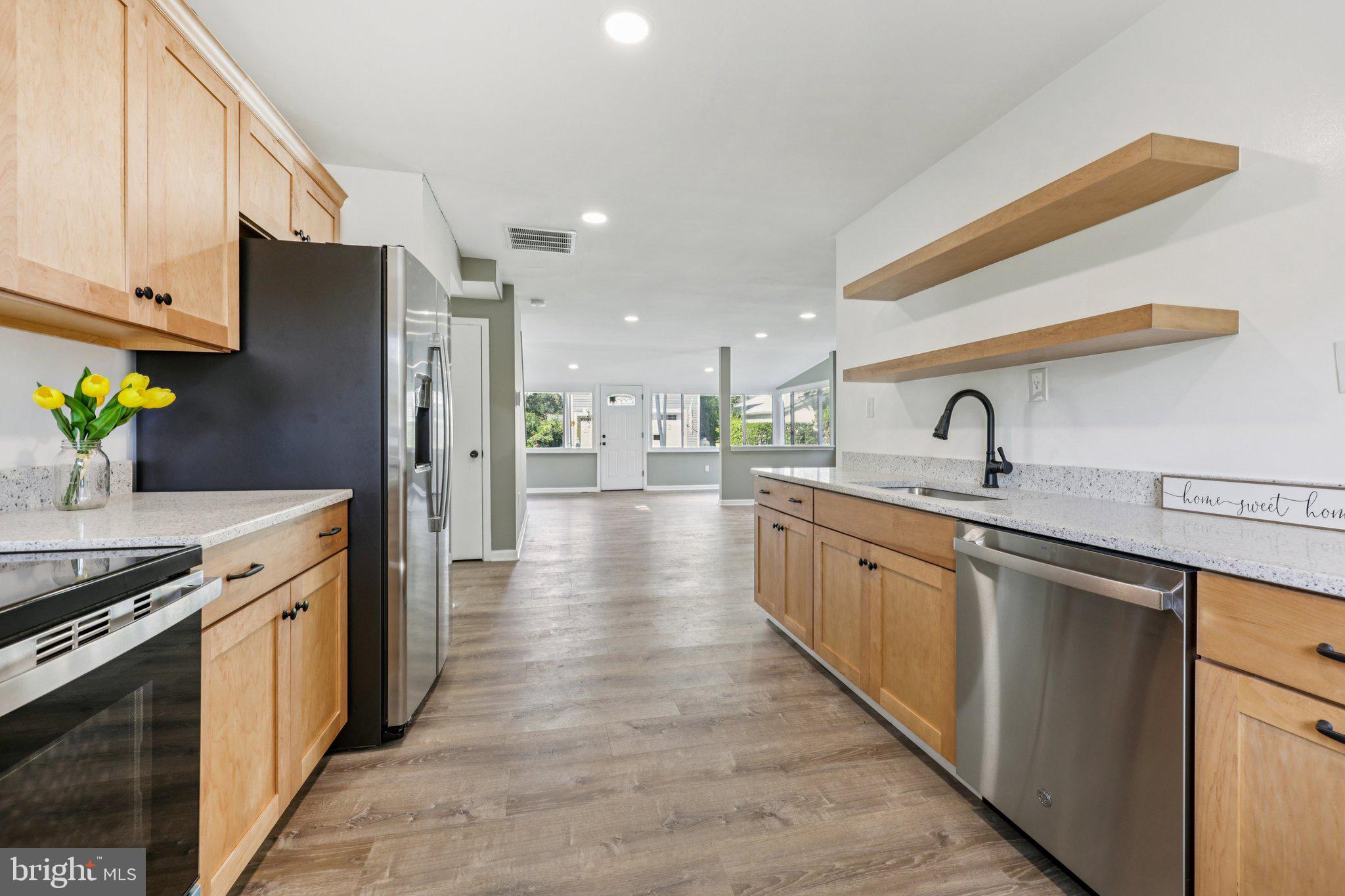 a kitchen with stainless steel appliances a sink stove and refrigerator