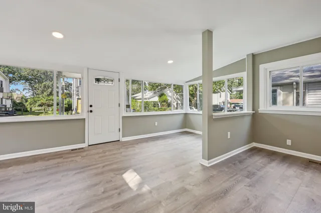 an empty room with large windows