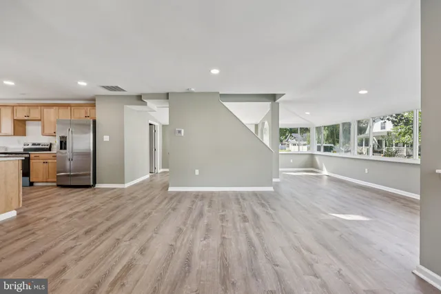 a view of a kitchen with a sink and a refrigerator