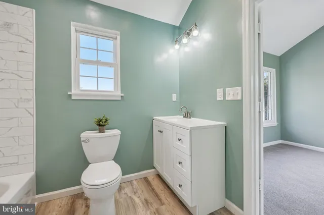 a bathroom with a toilet and a bathtub