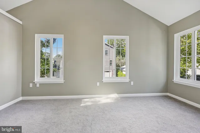 an empty room with windows and closet
