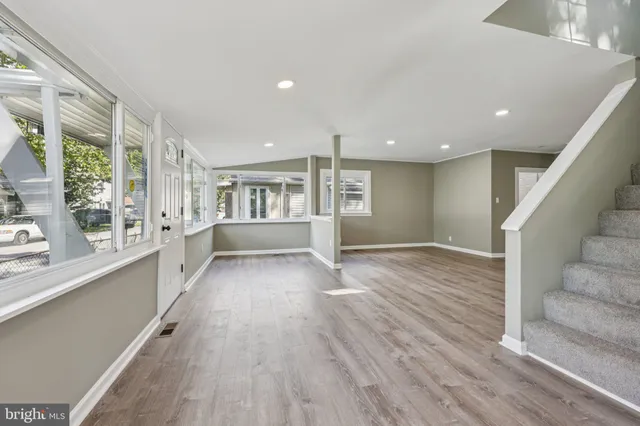 an empty room with windows and entrance