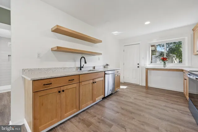 a kitchen with a sink cabinets and window