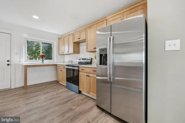 a kitchen with a sink stainless steel appliances and white cabinets