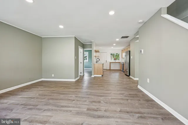 a view of an empty room with wooden floor