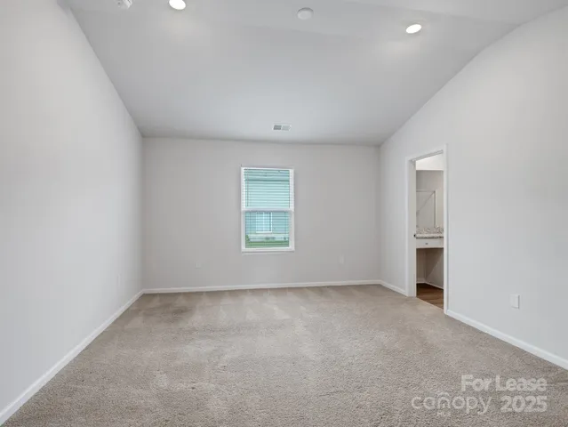 an empty room with a empty space and windows