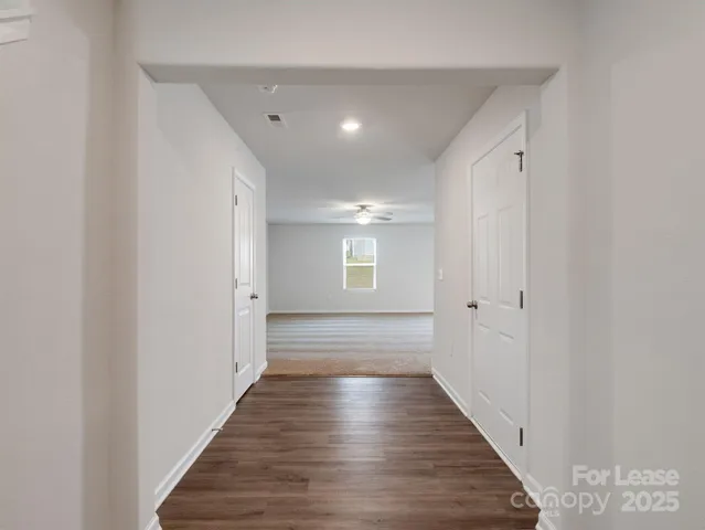 a view of hallway with wooden floor
