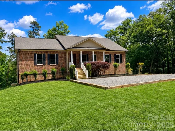 an aerial view of a house with a yard and lake view