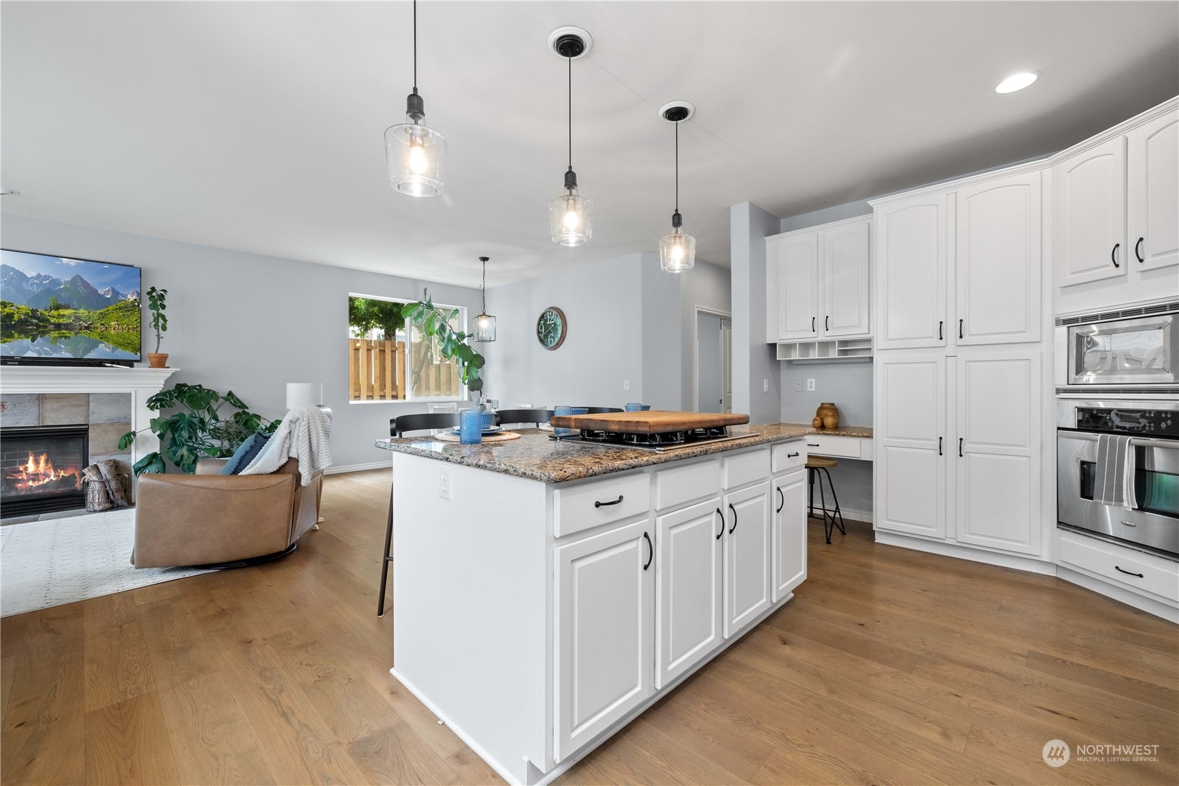 27648 Maple Ridge Way Southeast Maple Valley, WA 98038 - Photo 7 of 40 a large kitchen with kitchen island a stove a sink a center island and windows